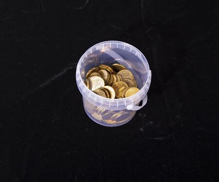 Iron 10 rubles coins (written ten rubles, the Bank of Russia in the Russian) over black backgroundの写真素材