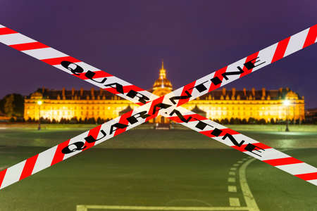 Coronavirus in Paris, France. Quarantine sign on a blurred background. Concept of COVID pandemic and travel in Europe.のeditorial素材