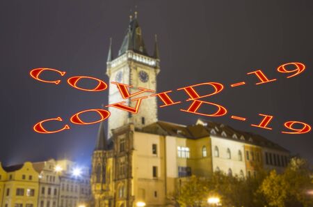 Coronavirus in Prague, Czech Republic. Old Town City Hall. Covid-19 sign on a blurred background. Concept of COVID pandemic and travel in Europe.の写真素材