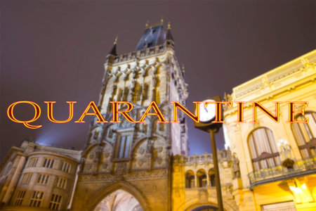Coronavirus in Prague, Czech Republic. Powder tower (gate) at evening. Quarantine sign on a blurred...