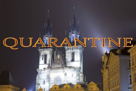 Coronavirus in Prague, Czech Republic. The gothic Church of Mother of God in front of Tyn. Quarantine sign on a blurred background. Concept of COVID pandemic and travel in Europe.の写真素材