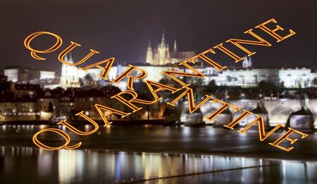 Coronavirus in Prague, Czech Republic. Vltava river, Charles Bridge and St. Vitus Cathedral. Quarantine sign on a blurred background. Concept of COVID pandemic and travel in Europe.の写真素材