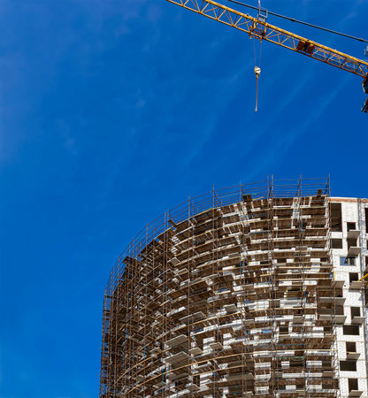 Multi-storey building under construction with scaffolding (new residential complex), Moscow, Russiaの写真素材