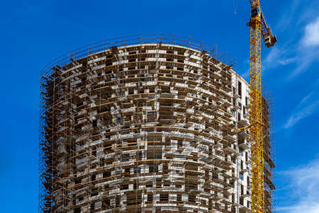 Multi-storey building under construction with scaffolding (new residential complex), Moscow, Russiaの写真素材