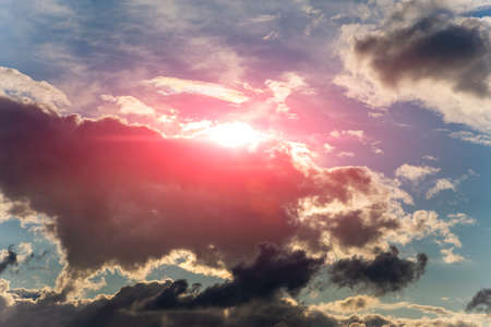 Dramatic evening sky with clouds and rays of the sun. The heavenly light of the sun. Sunlight at evening sunset or morning dawn. Heaven sunsetの写真素材