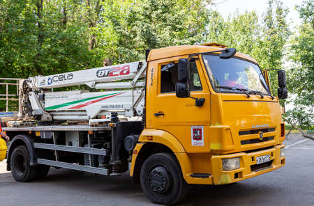 A car with a hydraulic lift plant in the courtyard of a residential building.The work of city utilities, Moscow, Russiaのeditorial素材