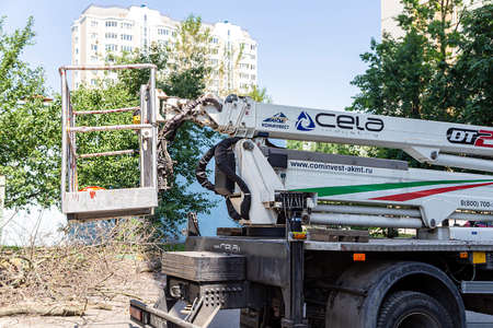 A car with a hydraulic lift plant in the courtyard of a residential building.The work of city utilities, Moscow, Russiaのeditorial素材