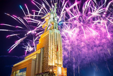 Celebratory colorful fireworks and soviet monument Rabochiy i Kolkhoznitsa (Worker and Kolkhoz Woman...