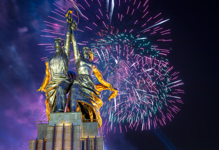 Celebratory colorful fireworks and soviet monument Rabochiy i Kolkhoznitsa (Worker and Kolkhoz Woman or Worker and Collective Farmer) of sculptor Vera Mukhina, Moscow, Russia. Made of in 1937のeditorial素材