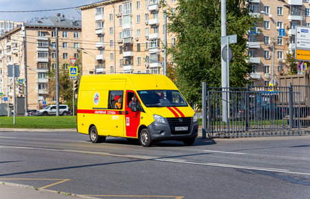 Yellow emergency service car on the road in the city. Moscow, Russia