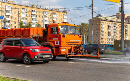 Sweeper machine on the road in the city (street sweeper). Community road services, street cleaning concept. Moscow, Russiaのeditorial素材