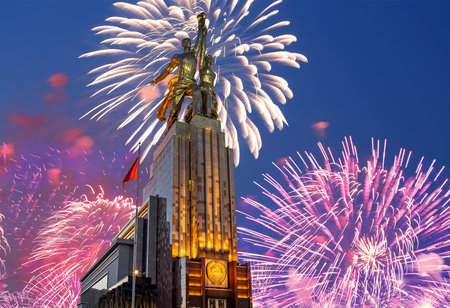 Celebratory colorful fireworks and soviet monument Rabochiy i Kolkhoznitsa (Worker and Kolkhoz Woman...