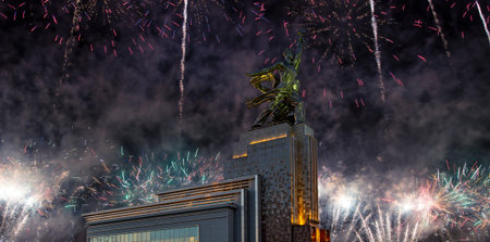 Celebratory colorful fireworks and soviet monument Rabochiy i Kolkhoznitsa (Worker and Kolkhoz Woman...