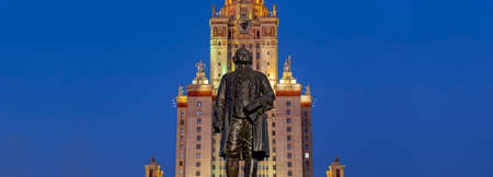 View of the monument to Mikhail Vasilyevich Lomonosov (autumn evening) from the side of the main building of Moscow State University (MSU) on Sparrow Hills, Russia.の写真素材