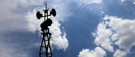 Contour small military radar station on background beautiful clouds and sky. Mobile relay stationの写真素材