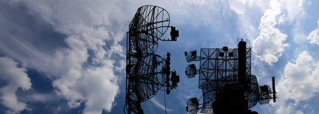 Air defense radars of military mobile anti aircraft systems, modern army industry on background...