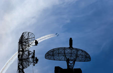 Air defense raiders of military mobile anti-aircraft complexes (radar is designed and automatic tracking of targets and missiles) against the background of the flight of modern combat fighters,Russiaの写真素材