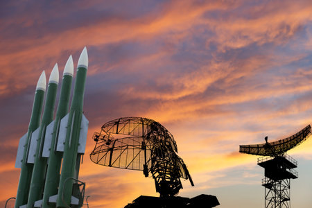 Air defense radars of military mobile anti aircraft systems and modern Russian anti-aircraft missiles OSA-AKM on the background of the sunset orange sky,Russiaの写真素材