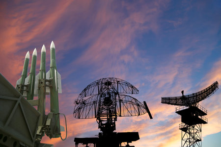 Air defense radars of military mobile anti aircraft systems and modern Russian anti-aircraft missiles OSA-AKM on the background of the sunset orange sky,Russiaの写真素材