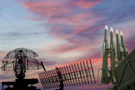 Air defense radars of military mobile anti aircraft systems and modern Russian anti-aircraft missiles OSA-AKM on the background of the sunset orange sky,Russiaの写真素材
