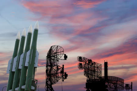 Air defense radars of military mobile anti aircraft systems and modern Russian anti-aircraft missiles OSA-AKM on the background of the sunset orange sky,Russiaの写真素材