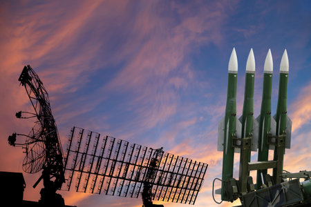Air defense radars of military mobile anti aircraft systems and modern Russian anti-aircraft missiles OSA-AKM on the background of the sunset orange sky,Russiaのeditorial素材