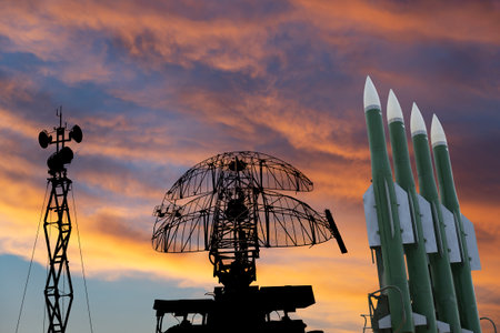 Air defense radars of military mobile anti aircraft systems and modern Russian anti-aircraft missiles OSA-AKM on the background of the sunset orange sky,Russiaのeditorial素材