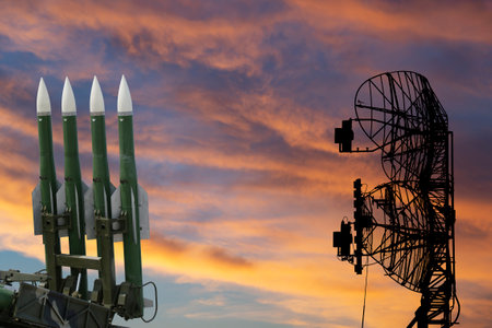 Air defense radars of military mobile anti aircraft systems and modern Russian anti-aircraft missiles OSA-AKM on the background of the sunset orange sky,Russiaのeditorial素材