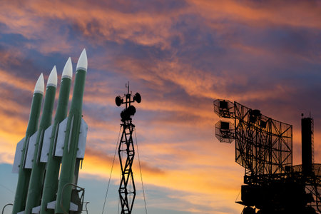 Air defense radars of military mobile anti aircraft systems and modern Russian anti-aircraft missiles OSA-AKM on the background of the sunset orange sky,Russiaのeditorial素材