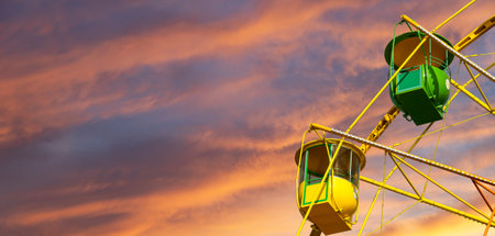 Attraction (carousel) ferris wheel against the background of a romantic evening skyの写真素材