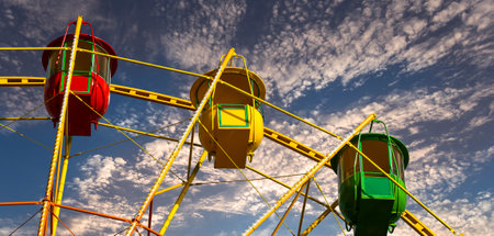 Attraction (carousel) ferris wheel against the background of a romantic evening skyの写真素材