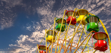 Attraction (carousel) ferris wheel against the background of a romantic evening skyの写真素材