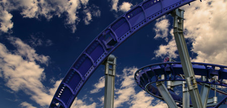 Attraction roller-coaster (switchback) against the background of a romantic evening skyの写真素材