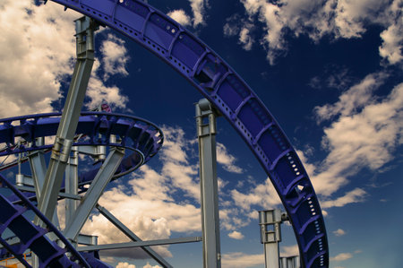 Attraction roller-coaster (switchback) against the background of a romantic evening skyの写真素材