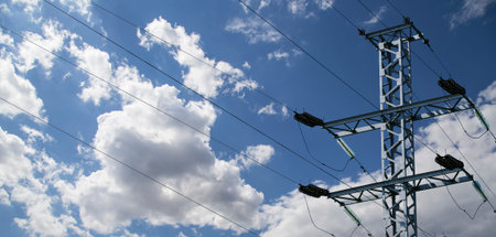 Electricity pylon (high voltage power line) on the background of the cloudy sky