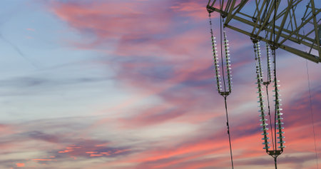 Electricity pylon (high voltage power line) against the background of a romantic evening skyの写真素材