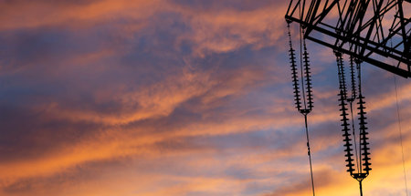 Electricity pylon (high voltage power line), black contour, against the background of a romantic...