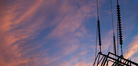 Electricity pylon (high voltage power line), black contour, against the background of a romantic...