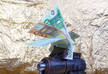 Allegory of the global financial crisis - EURO in the grip of economic crisis, on a white backgroundの写真素材