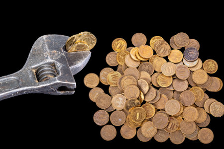 Allegory of the global financial crisis - Iron 10 rubles coin (written ten rubles, Bank of Russia in the Russian) in the grip of economic crisis, on a black background. Finance and business conceptの写真素材