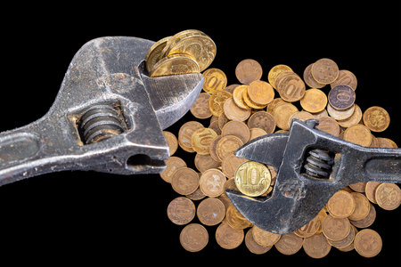 Allegory of the global financial crisis - Iron 10 rubles coin (written ten rubles, Bank of Russia in the Russian) in the grip of economic crisis, on a black background. Finance and business conceptの写真素材