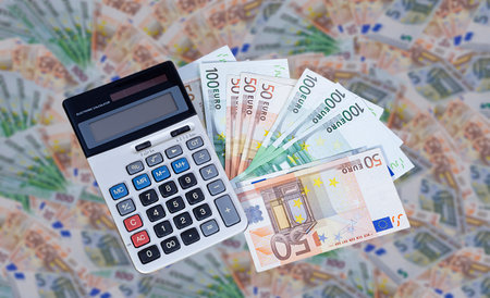 Calculator on a pile of EURO bills. Finance and business conceptの写真素材