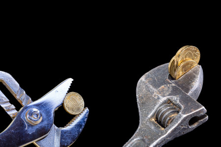 Allegory of the global financial crisis - Iron 10 rubles coin (written ten rubles, Bank of Russia in the Russian) in the grip of economic crisis, on a black background. Finance and business conceptの写真素材