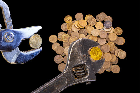 Allegory of the global financial crisis - Iron 10 rubles coin (written ten rubles, Bank of Russia in the Russian) in the grip of economic crisis, on a black background. Finance and business conceptの写真素材