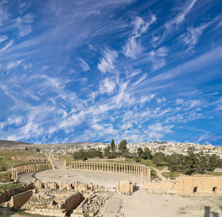 Forum (Oval Plaza) in Gerasa (Jerash), Jordan. Was built in the first century AD. Against the background of a beautiful sky with clouds.の写真素材