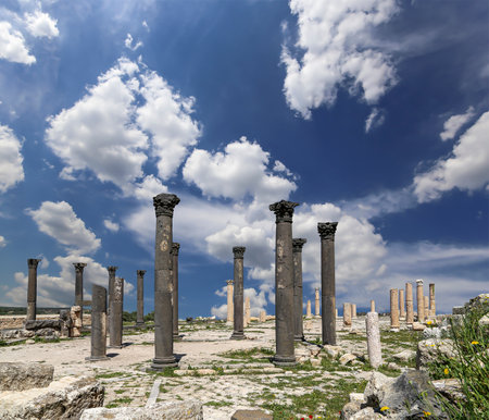 Roman ruins at Umm Qais (Umm Qays)--is a town in northern Jordan near the site of the ancient town of Gadara, Jordan. Against the background of a beautiful sky with cloudsの写真素材