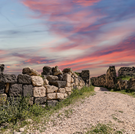 Roman ruins at Umm Qais (Umm Qays)--is a town in northern Jordan near the site of the ancient town of Gadara, Jordan. Against the background of a beautiful sky with cloudsの写真素材