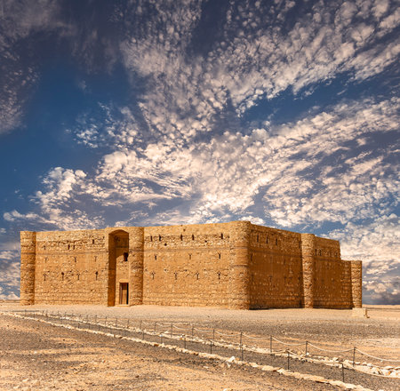 Qasr Kharana (Kharanah or Harrana)-- desert castle in eastern Jordan (100 km of Amman). Built in 8th century AD to be used as caravanserai, a resting place for traders. Against the sky with cloudsの写真素材