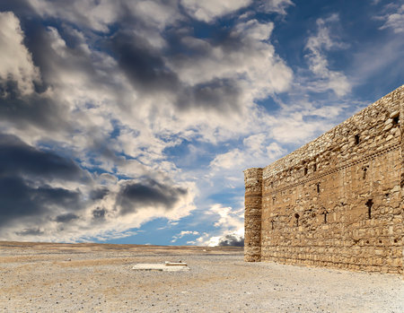 Qasr Kharana (Kharanah or Harrana)-- desert castle in eastern Jordan (100 km of Amman). Built in 8th century AD to be used as caravanserai, a resting place for traders. Against the sky with cloudsの写真素材