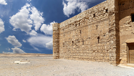 Qasr Kharana (Kharanah or Harrana)-- desert castle in eastern Jordan (100 km of Amman). Built in 8th century AD to be used as caravanserai, a resting place for traders. Against the sky with cloudsの写真素材